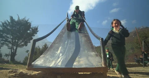 Low angle view of children playing on slide at Namche Bazaar, mountain Stockbeeldmateriaal 337396178