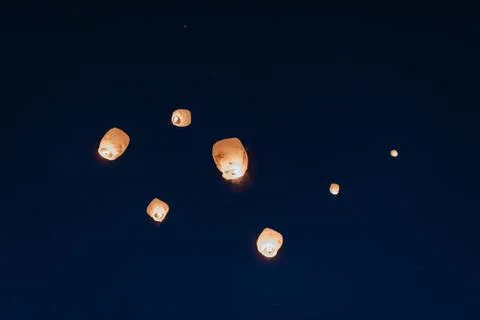 Low angle view of Chinese Lanterns released into night sky. Stock Photos