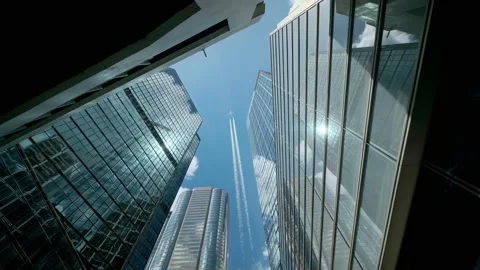 Low angle view of city skyline buildings with commercial aircraft. Stock Footage 157851061