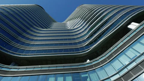 Low angle view of city skyline buildings, blue sky and glass mirrored facades. 스톡 동영상 331621864