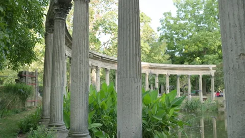 Low Angle View of Classical Corinthian Colonnade Along the Pond Edge with Camera Stock Footage 340477134