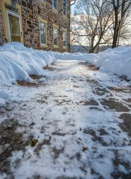 Low angle view of cleared walkway to houise front door after snow storm win.. Stock Photos