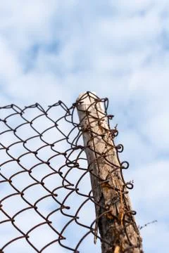 Low angle view close-up of wire wood fence against light blue sky, abstract o Stock Photos