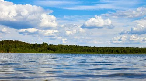 Low angle view of cloudscape and water surface Stock Photos