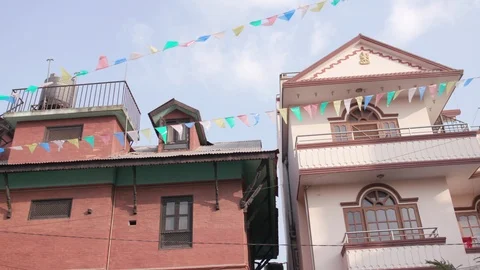 Low angle view of colorful bunting in front of the buildings in Nepal Stock Footage 104432367