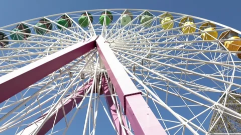 Low angle view of colorful ferris wheel spinning at amusement park Stock Footage 278840372