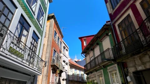 Low-angle view of colorful old buildings with balconies in a narrow histori.. Stock Footage 327632934