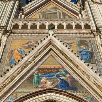 Low angle view of the colourful painted facade of Orvieto Cathedral Stock Photos