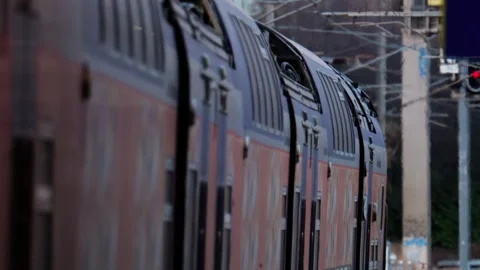 Low angle view of commuter train carriages moving past railway signal in ur.. Stock Footage 339753276