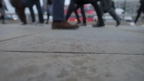 Low angle view of commuters feet as it starts to rain on london bridge Video stock 96452619