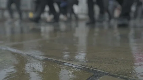 Low angle view of commuters walking in the rain at rush hour 스톡 동영상 118241121