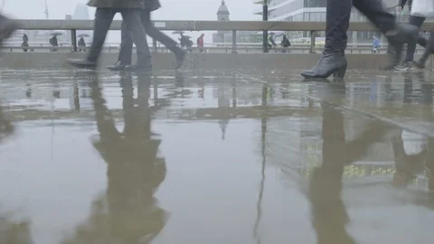Low angle view of commuters walking in the rain at rush hour Video stock 118242698