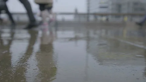 Low angle view of commuters walking in the rain at rush hour 스톡 동영상 118243158