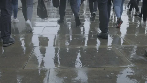 Low angle view of commuters walking in the rain at rush hour Stock Footage 118252830