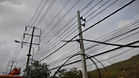 Low angle view of complex overhead power lines with thick twisted aerial. Stock Photos