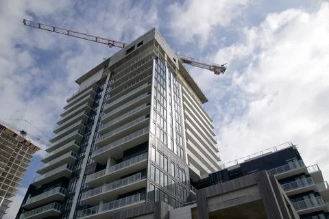 Low angle view of construction site with cranes and buildings Stock Photos