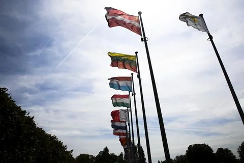 Low angle view of country flags on flagpoles Stock Photos