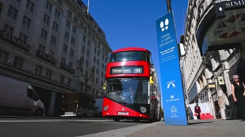 A low angle view of a COVID sign next to the road on a London street with a R Stock Footage 159234241