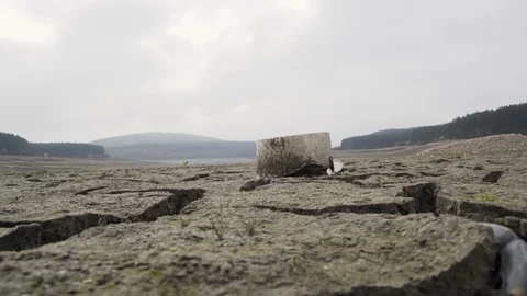 Low angle view of cracked dried mud bottom of Studena dam near Pernik. Reservoir Stock Footage 120730262