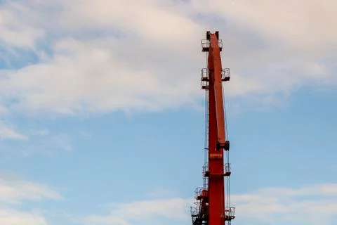 Low angle view of crane grabber with bauxite ore against bleached sky in the  Foto stock