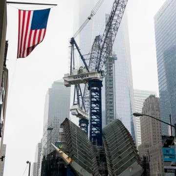 Low angle view of a crane by modern skyscrapers in Manhattan Stock Photos