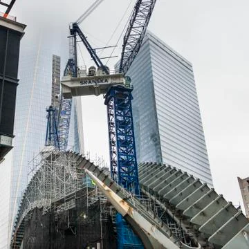 Low angle view of a crane by modern skyscrapers in Manhattan Stock Photos