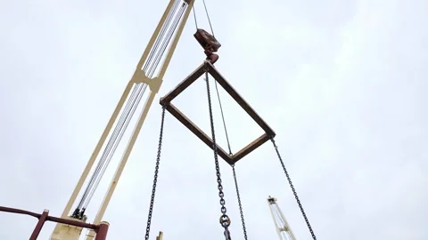Low Angle View of Crane Spreader Bar and Lifting Chains for Heavy Cargo Handling Stock Footage 342612940