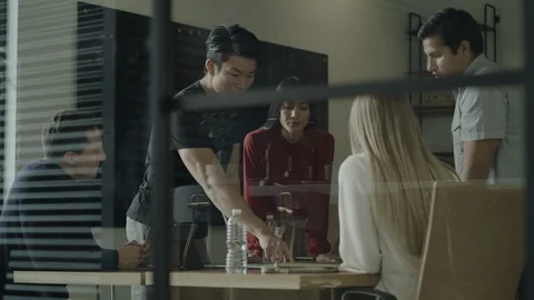 Low angle view of creative business people brainstorming in meeting / Stock Footage 124616184