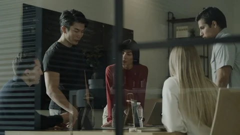 Low angle view of creative business people brainstorming in meeting / Stock Footage 124616247