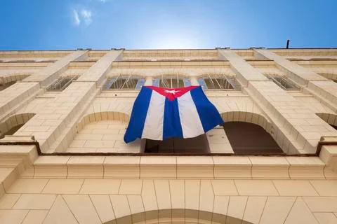 Low angle view of Cuban flag hanging on building against sky in city Fotos de archivo