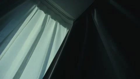 Low angle view of curtains closing, blocking evening light. Cozy indoor Stock-Footage 334943884