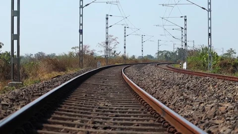 Low angle view of curved railway track with electric overhead lines Stock Footage 330705723