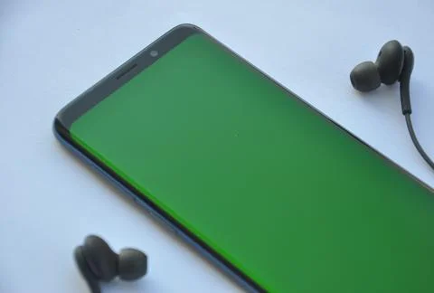 Low angle view of curved screen mobile phone with green screen Stock Photos