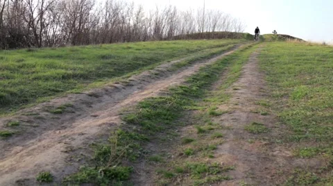 Low angle view of cyclist riding mountain bike on rocky trail at sunrise Video stock 65729415