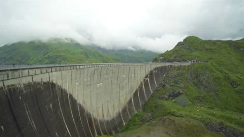 Low angle view of a dam high in the mountains with fog and clouds Stock Footage 122061513