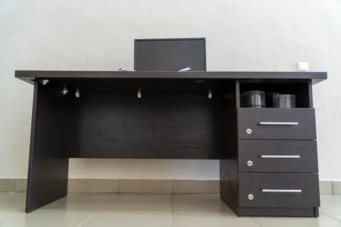 Low angle view of dark brown wooden office desk Stock-Fotos