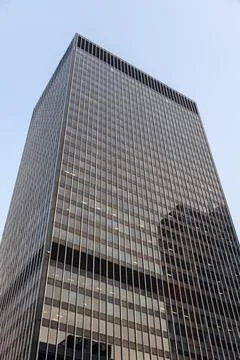 Low angle view of dark skyscraper. Modern office tower in city Stock Photos