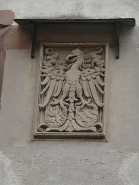Low angle view of detailed stone carving of imperial eagle and coat of arms.. Stock Photos