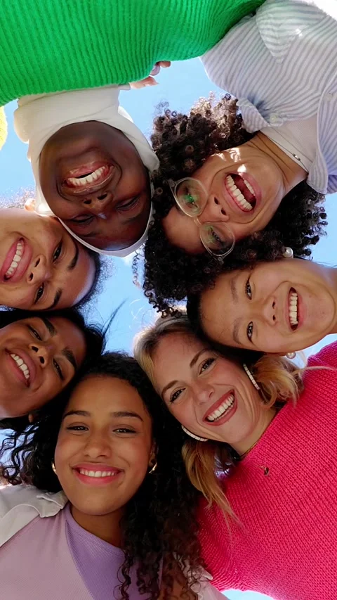 Low angle view of diverse group of young women hugging each other outdoors Stock Footage 312235336