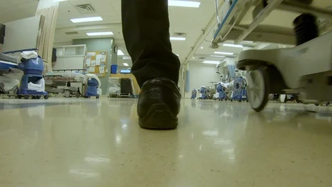 Low angle view as a doctor and nurse transfer a patient on a gurney Stock Footage 119888070