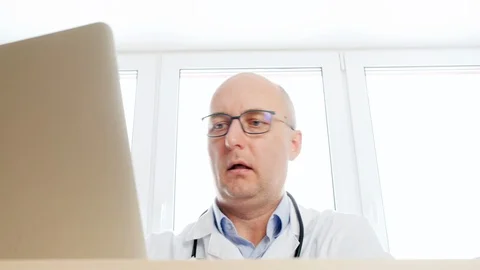 Low angle view of doctor working with laptop Video stock 126476260