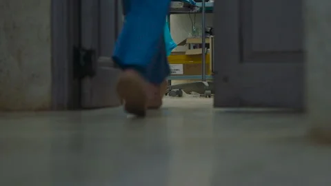 Low angle view of doctors and nurses feet walking along the floor of a busy Stock Footage 336532952