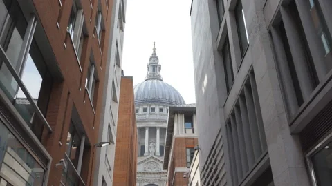 A low angle view of the dome of a cathedral from between two buildings. Video stock 125949666