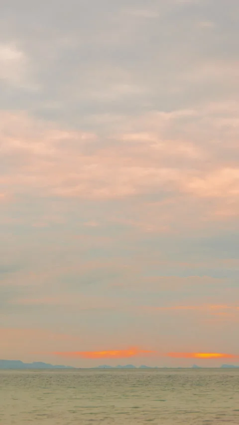 Low Angle View of Dramatic Clouds Moving Swiftly Across a Colorful Sunset Sky Stock Footage 310995016