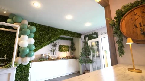 Low angle view of a drinks station, balloons and hedge walls Stock Footage 345555166