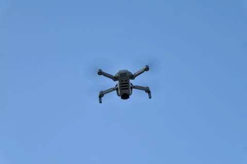 Low angle view of drone flying against clear blue sky Stock Photos