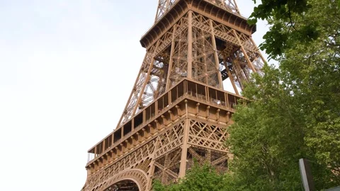 Low Angle View of Eiffel Tower Architecture and Green Foliage in Paris Stock Footage 334652944