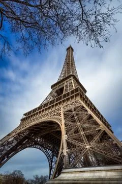 Low angle view Eiffel Tower and passing clouds, Paris, France Stock Photos