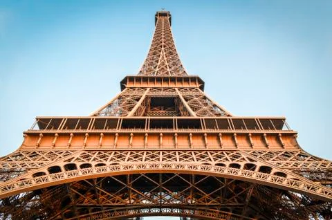 Low angle view of the Eiffel Tower in Paris,  Champs de Mars against a blue sky. Photos