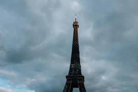 Low-angle view of the Eiffel tower against a cloudy stormy sky in Paris, France Stock Photos